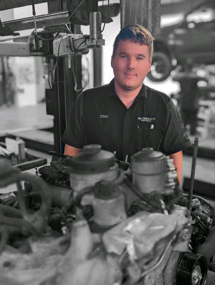 auto repair expert in diesel garage black and white
